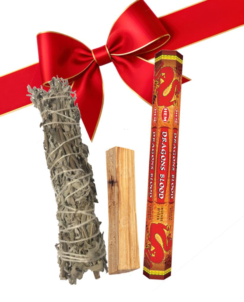 Smudging stick, palo santo, and 'Dragon's Blood' incense with a red bow on a white background