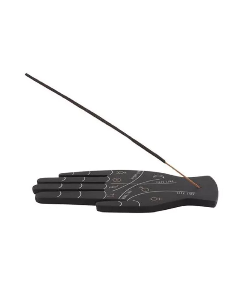 Black incense holder with engraved design and a single incense stick on a white background