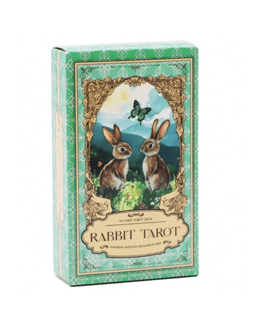 A boxed tarot card deck titled 'Rabbit Tarot' with a decorative mint green and cream package design, featuring an illustration of two rabbits under a butterfly on the front.